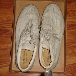 Of white leather boots. Made from crock and ostrich skins, laced.